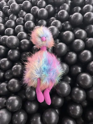 A photo of Rainbow Pompom Jellycat taken by travelerstoys